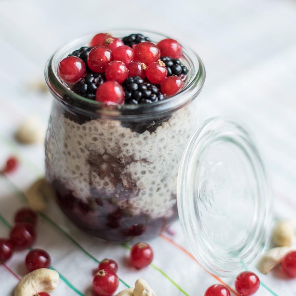 Chiapudding in kleinem Glas mit Johannisbeeren und Brombeeren getoppt